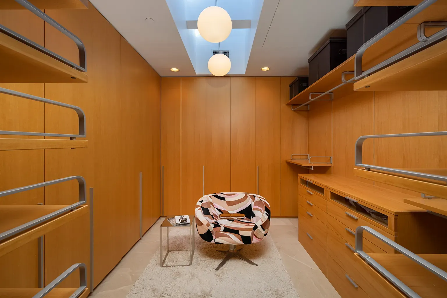 Minimalist storage heaven—warm honey panels, endless cabinets. You could hide a family here.