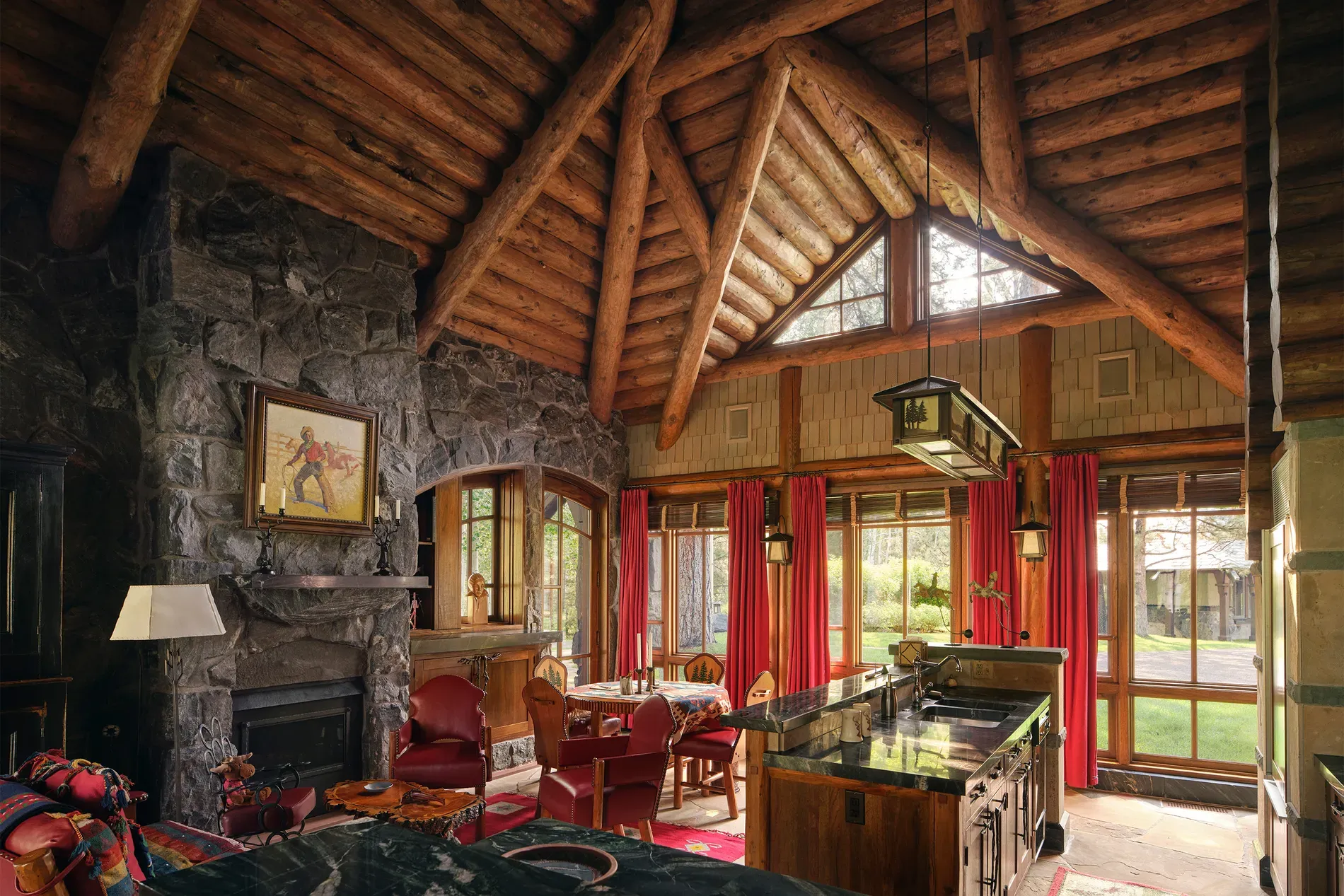Kitchen-dining under log vaults. Cozy lodge vibe, but those logs are massive.
