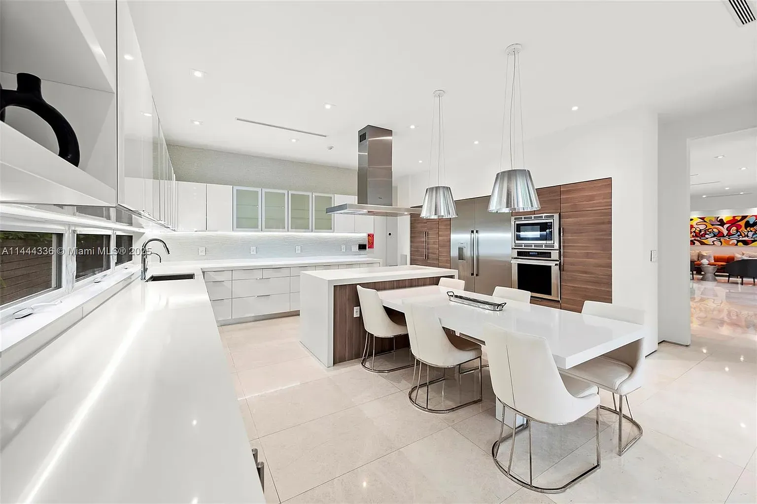 Here’s the kitchen — white and wood, giant glossy island begging for snacks.