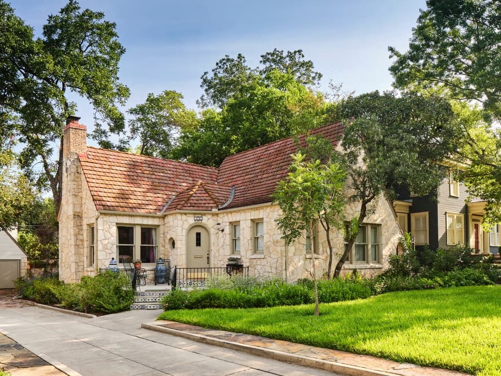 Here's the cottage—creamy stone and ridgey tile roof. Cute, storybook vibes.