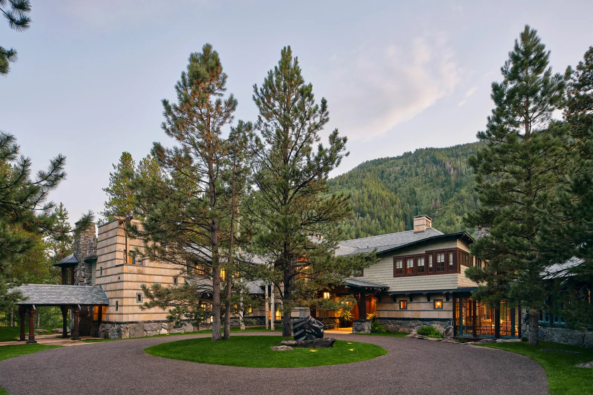 Here's the exterior—stone, warm wood, big pines, mountains. $300M first impression does hit.