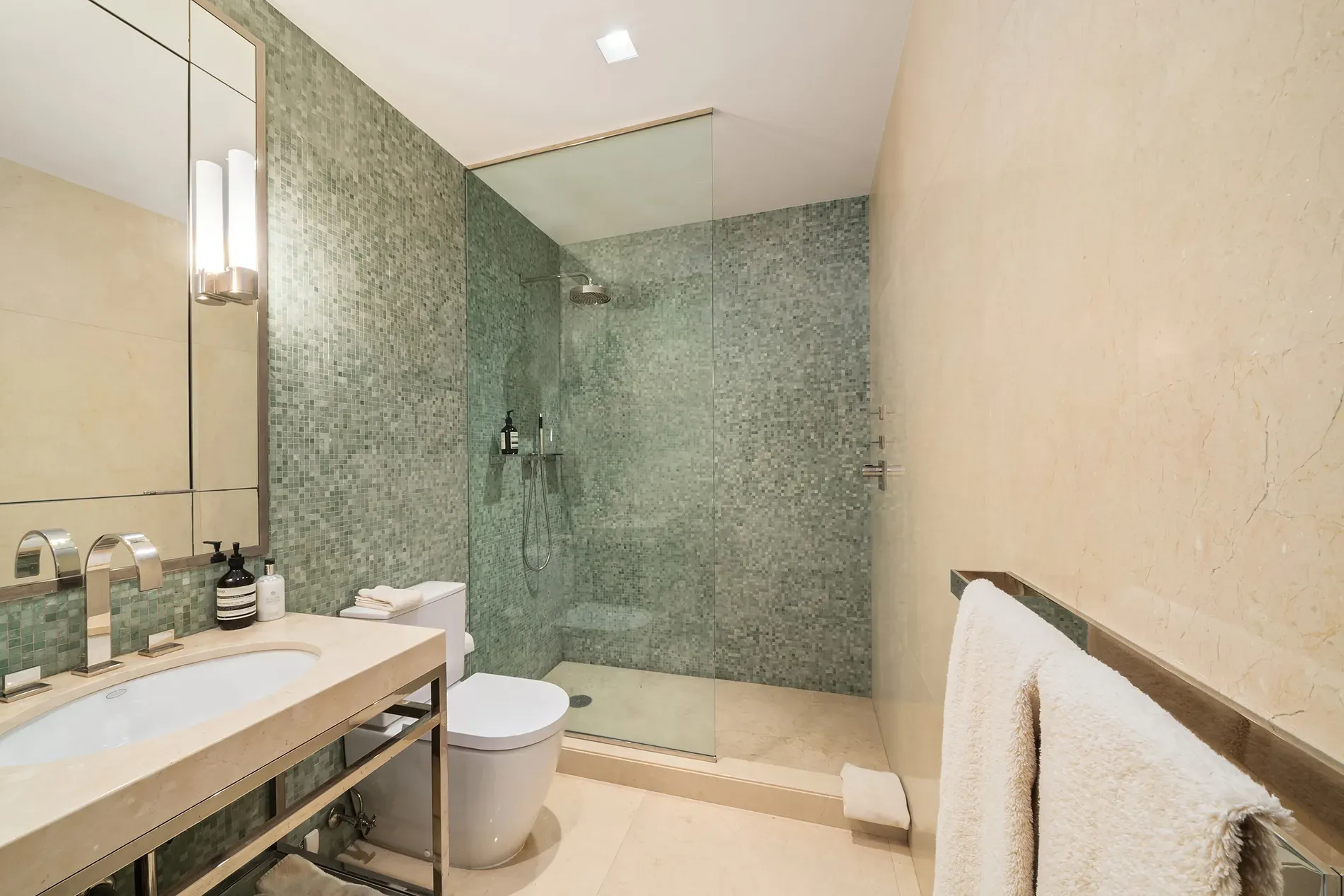 Green mosaic shower wall is gorgeous. Spa vibes without trying too hard.