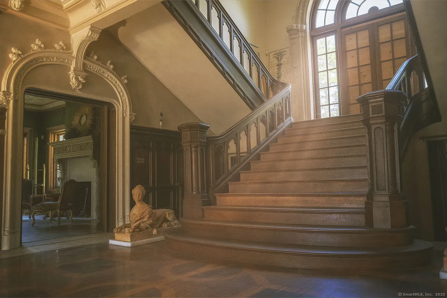 Here's the entry - curved staircase, glossy wood. Feels a movie set.