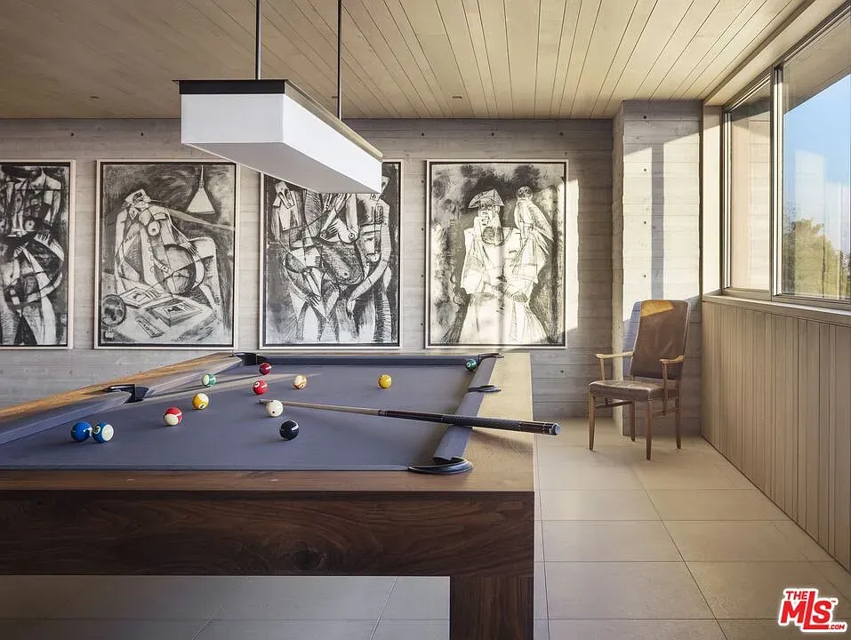 Game room flex. matte black table, neon-bright balls. Serious lounge energy.