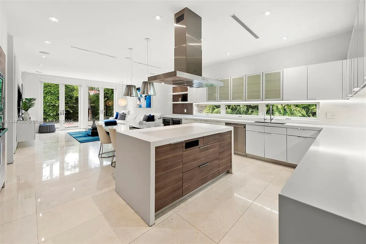 Wait, second kitchen? Glossy whites, brown island, looks fancy. Do they cater?