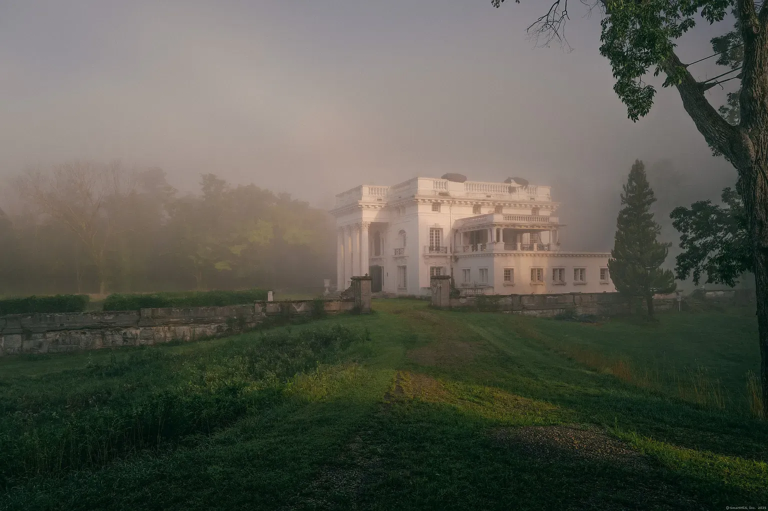 Closer view of the mansion - white disappears into fog. Spooky, but elegant.