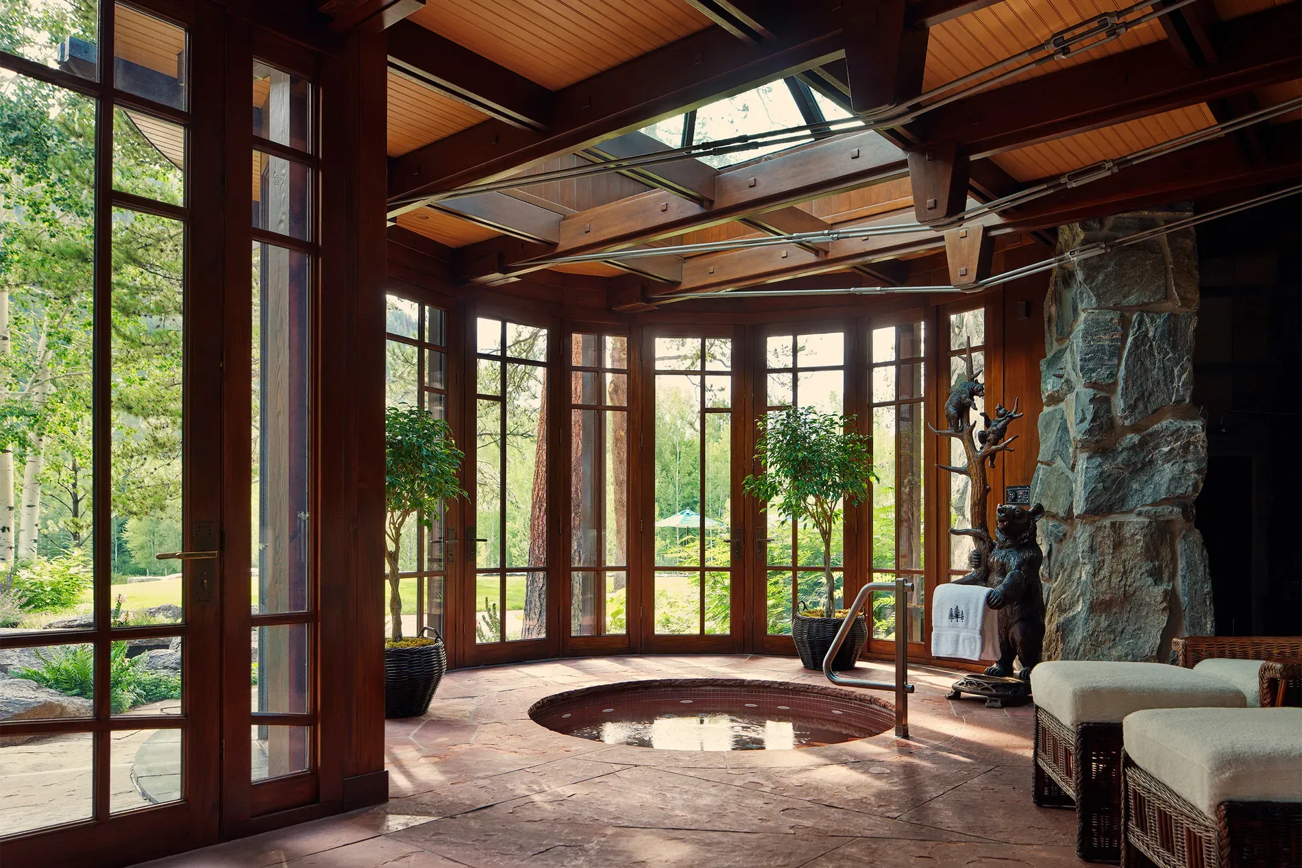 Sunken circular hot tub by glass walls. Gorgeous, sure, but $300M slip-n-slide?
