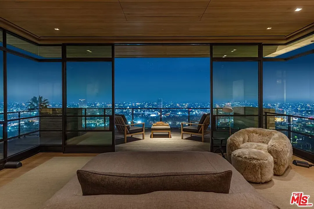 Open living with those floor-to-ceiling views. Warm wood ceiling keeps it cozy.