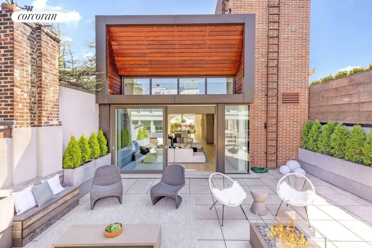 Here's the terrace—huge neutral tiles, clipped greenery, and that view. Instant zen.