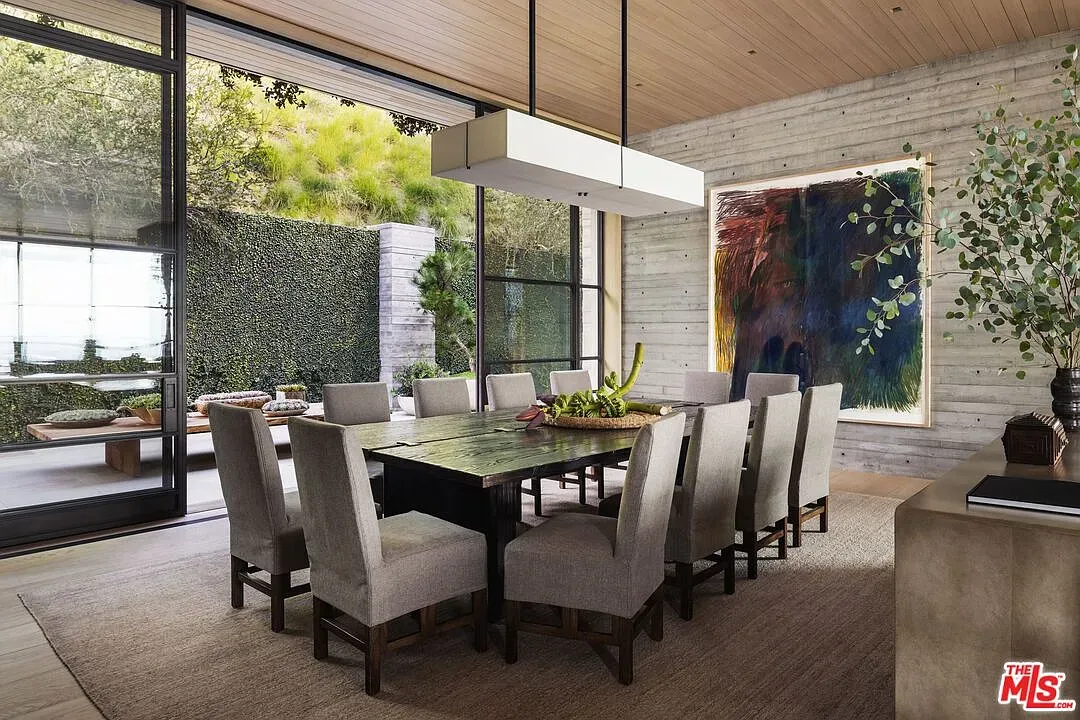 Dining for ten without drama. Big wood table, soft chairs, easy conversation.