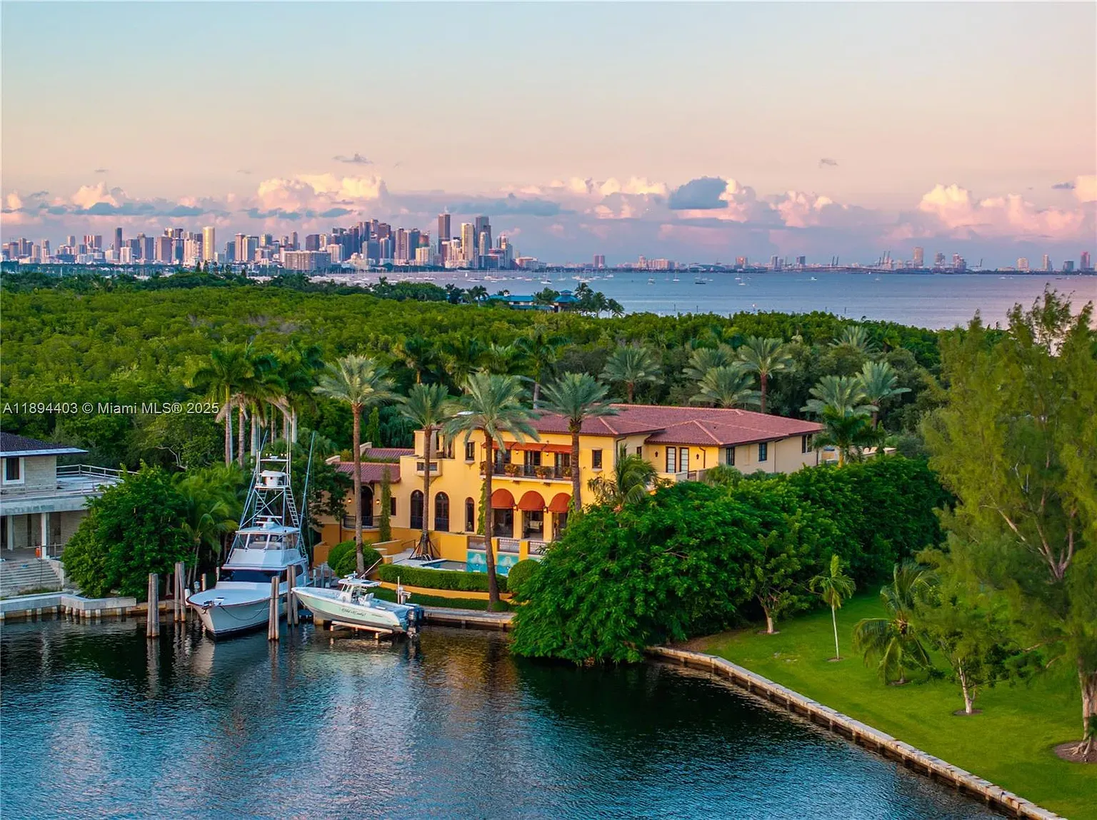 Here's the waterfront villa — sandy stucco, terracotta, Miami skyline flex.