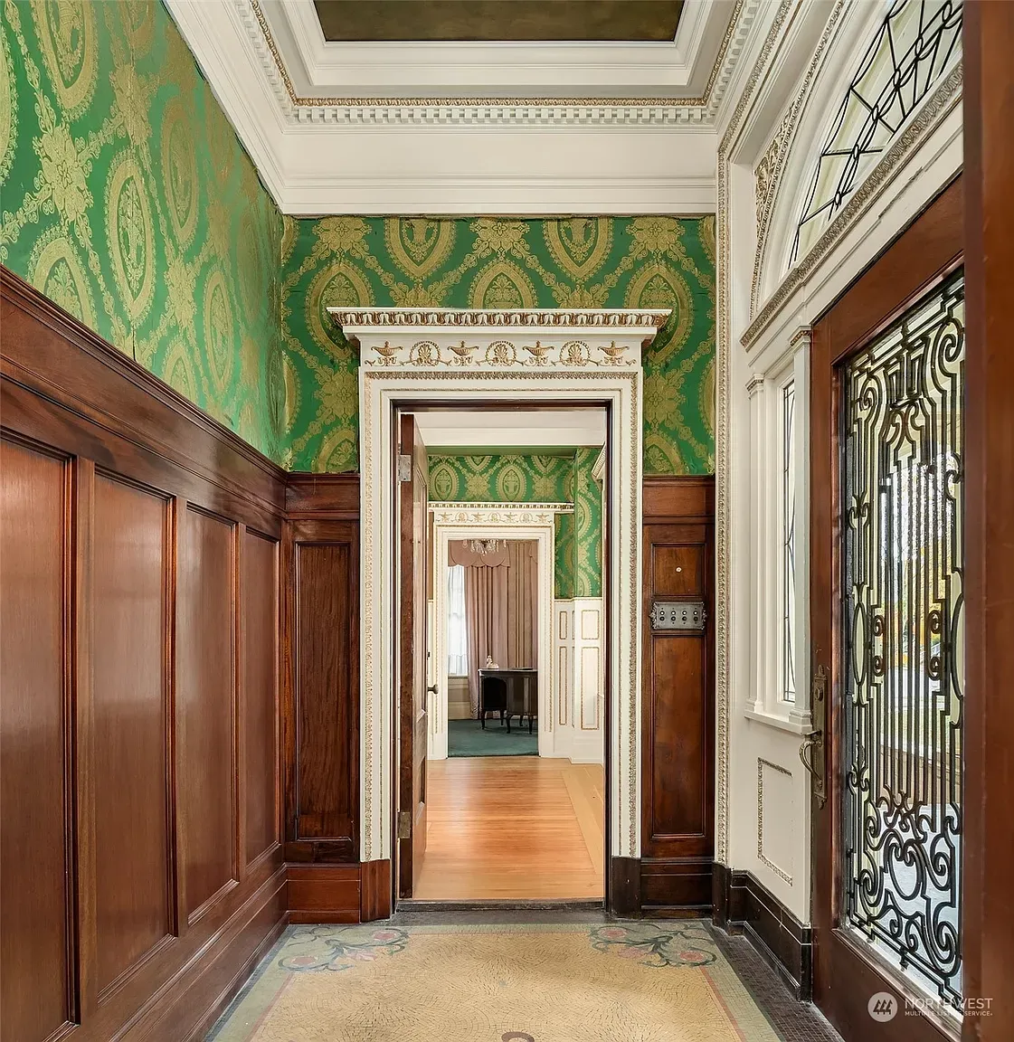 Entry goes full drama. green damask walls, big contrast, instant formal vibes.