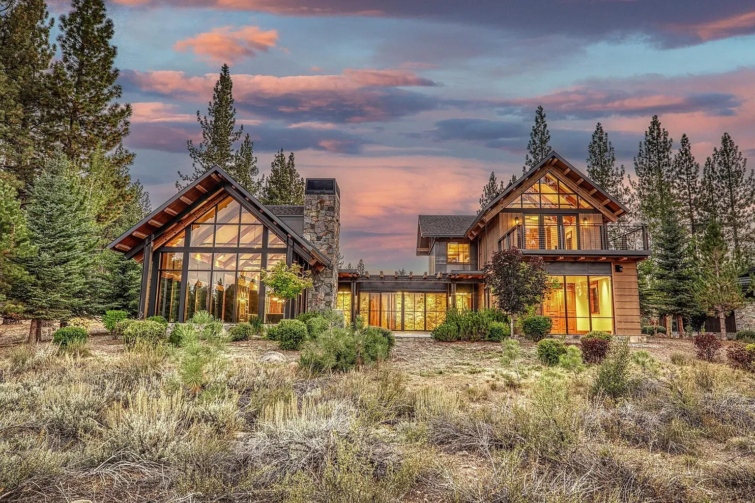 Another angle of the exterior—wood cladding and giant panes soaking up the forest.