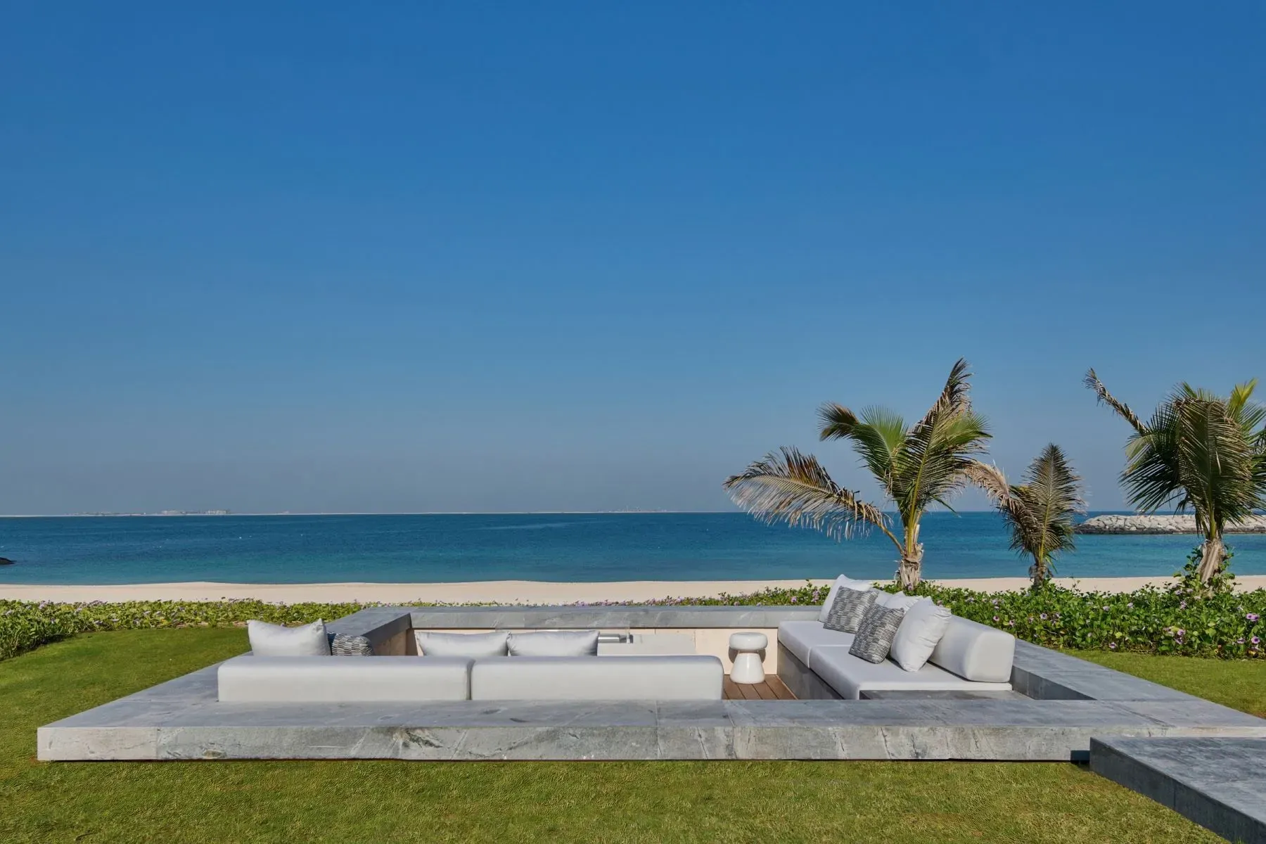 Sunset lounge zone. Low sofa, big cushions, bring me a drink.