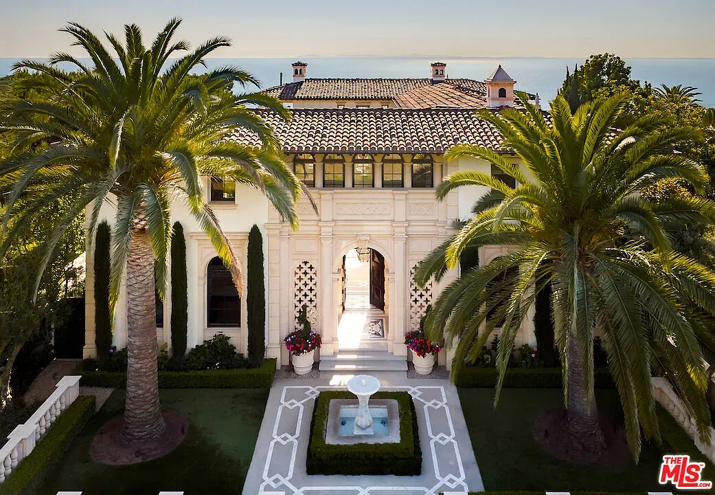 Here's the front—palms, tiled facade, big Mediterranean vibes. Kinda movie-set grand.