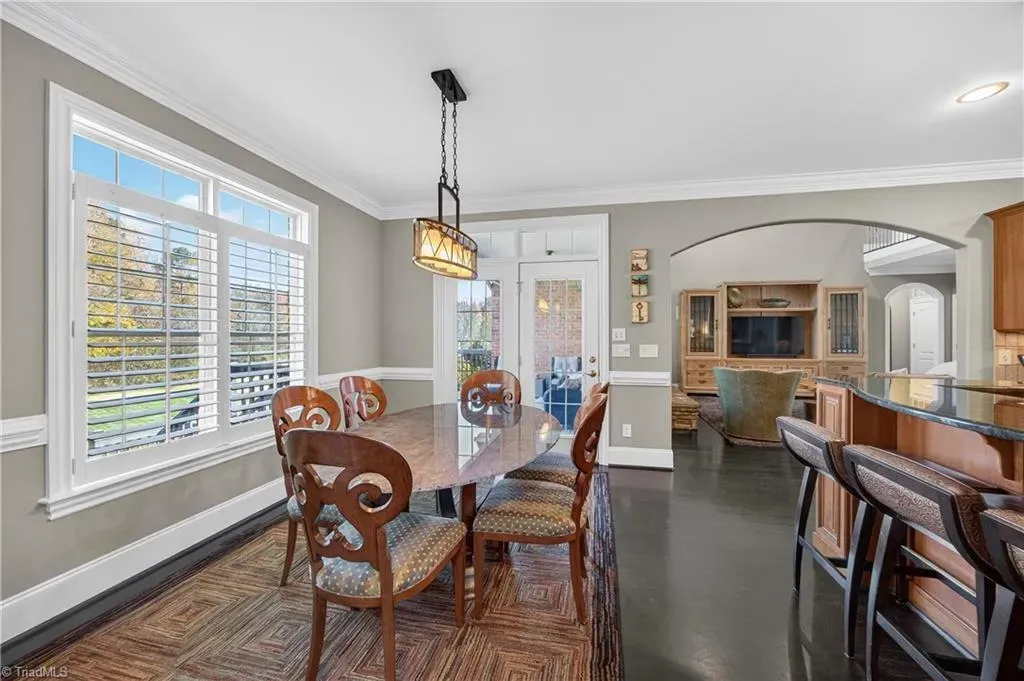 Oval table with carved chairs feels fancy but still weeknight-dinner friendly.