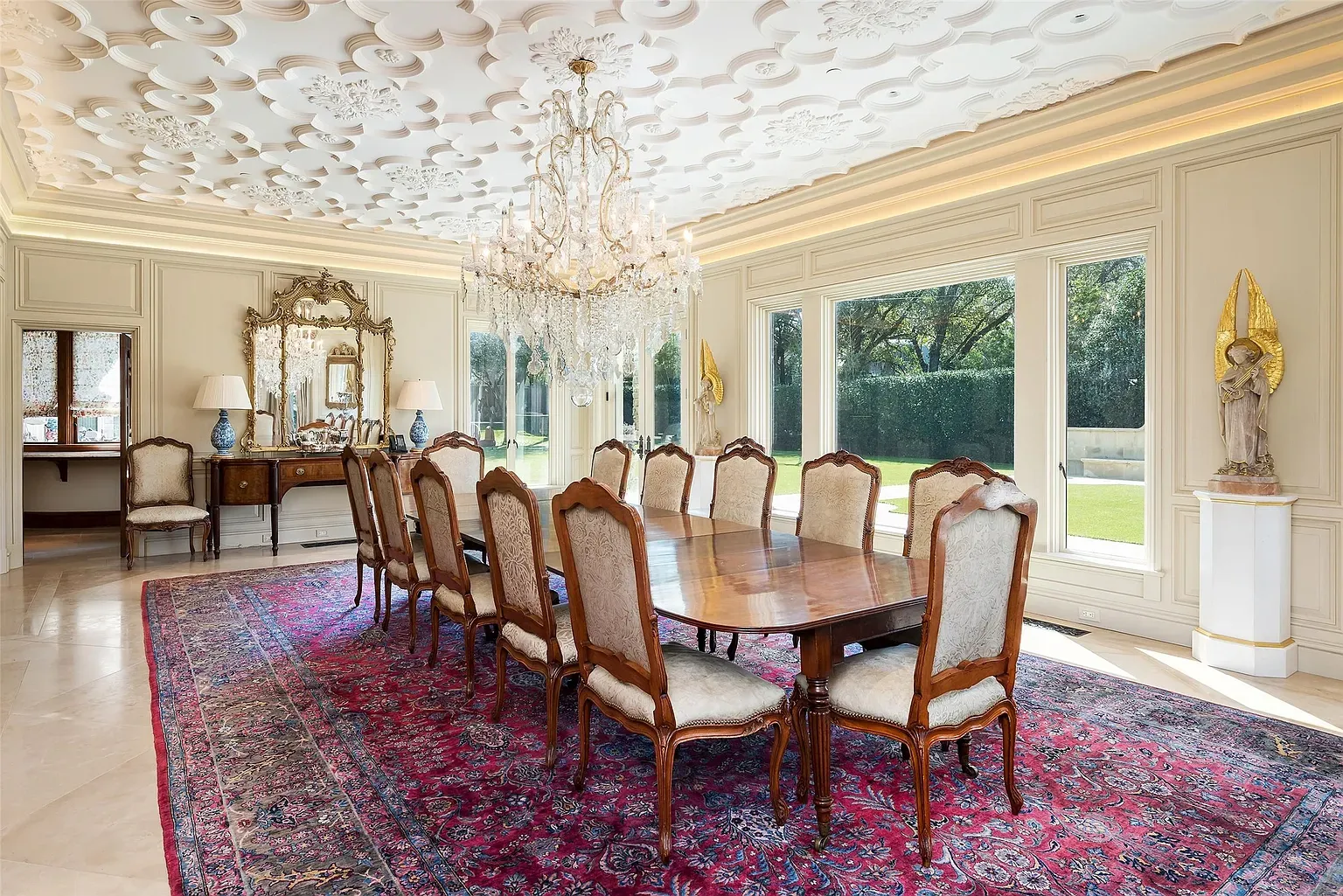 Ceiling steals the show—floral plasterwork and a chandelier doing the most.
