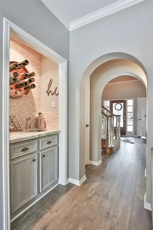 Long, bright hallway with pale wood floors. Feels it goes forever.