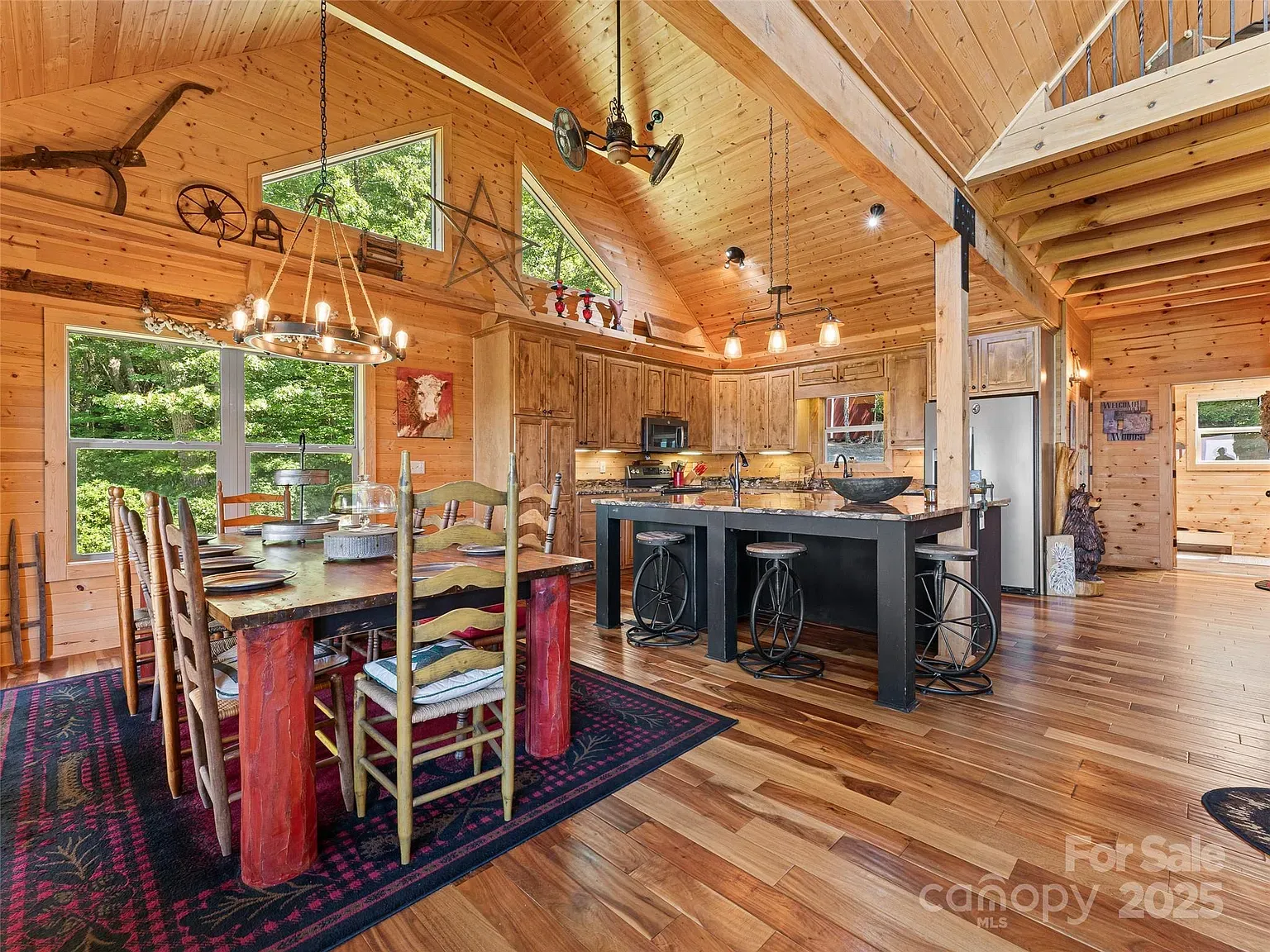 The kitchen-dining combo with vaulted beams makes me weirdly excited to cook.