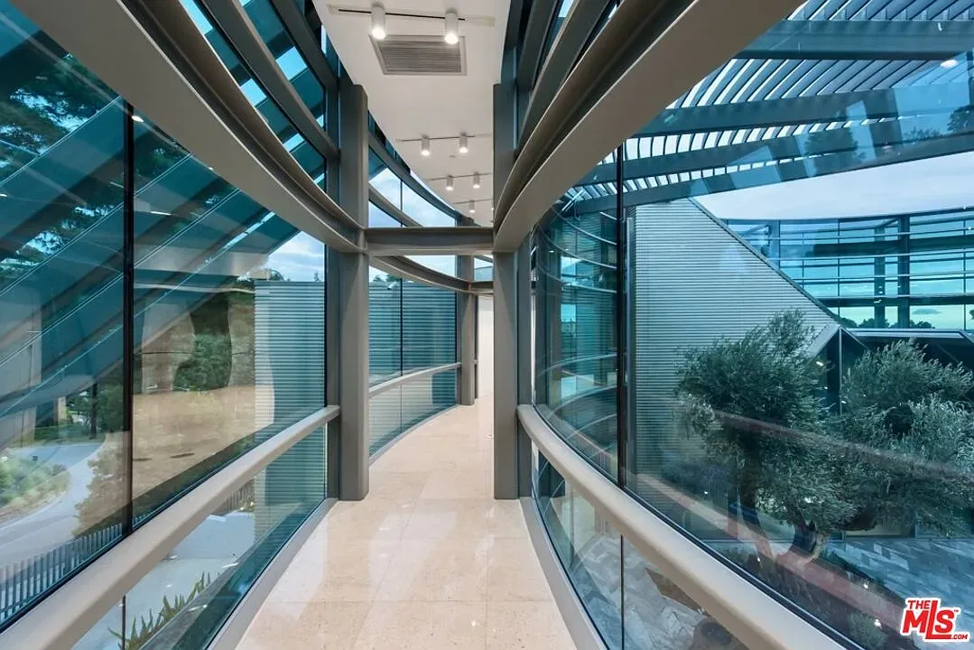 Hallway is a glass curve. Feels walking through a gallery.