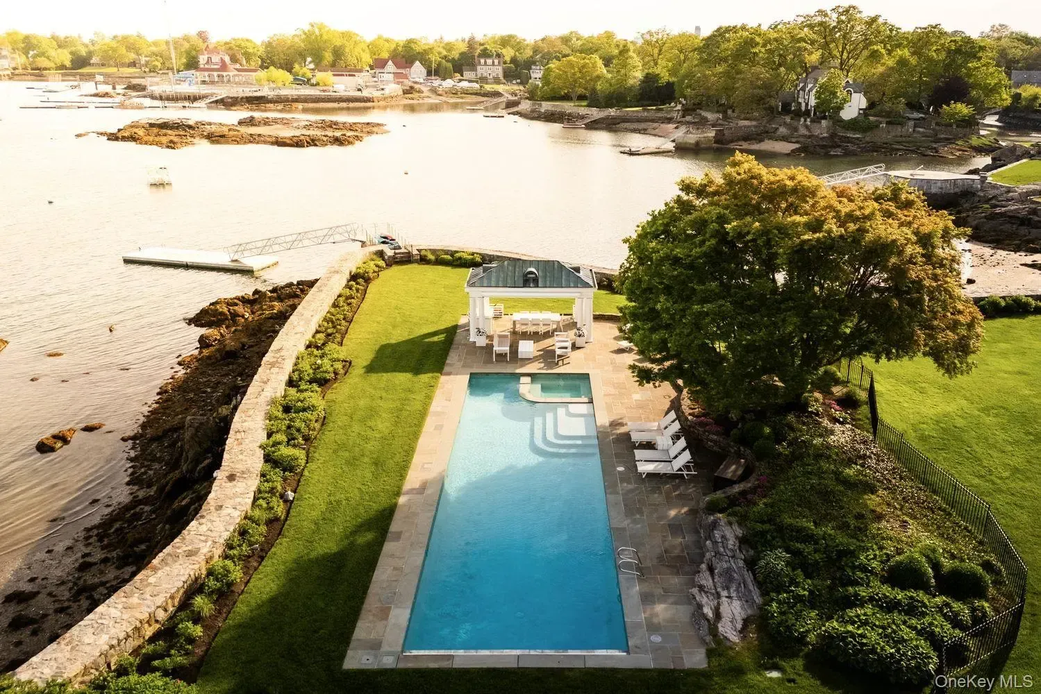 That pool right on the water. Stone deck looks toes-approved.