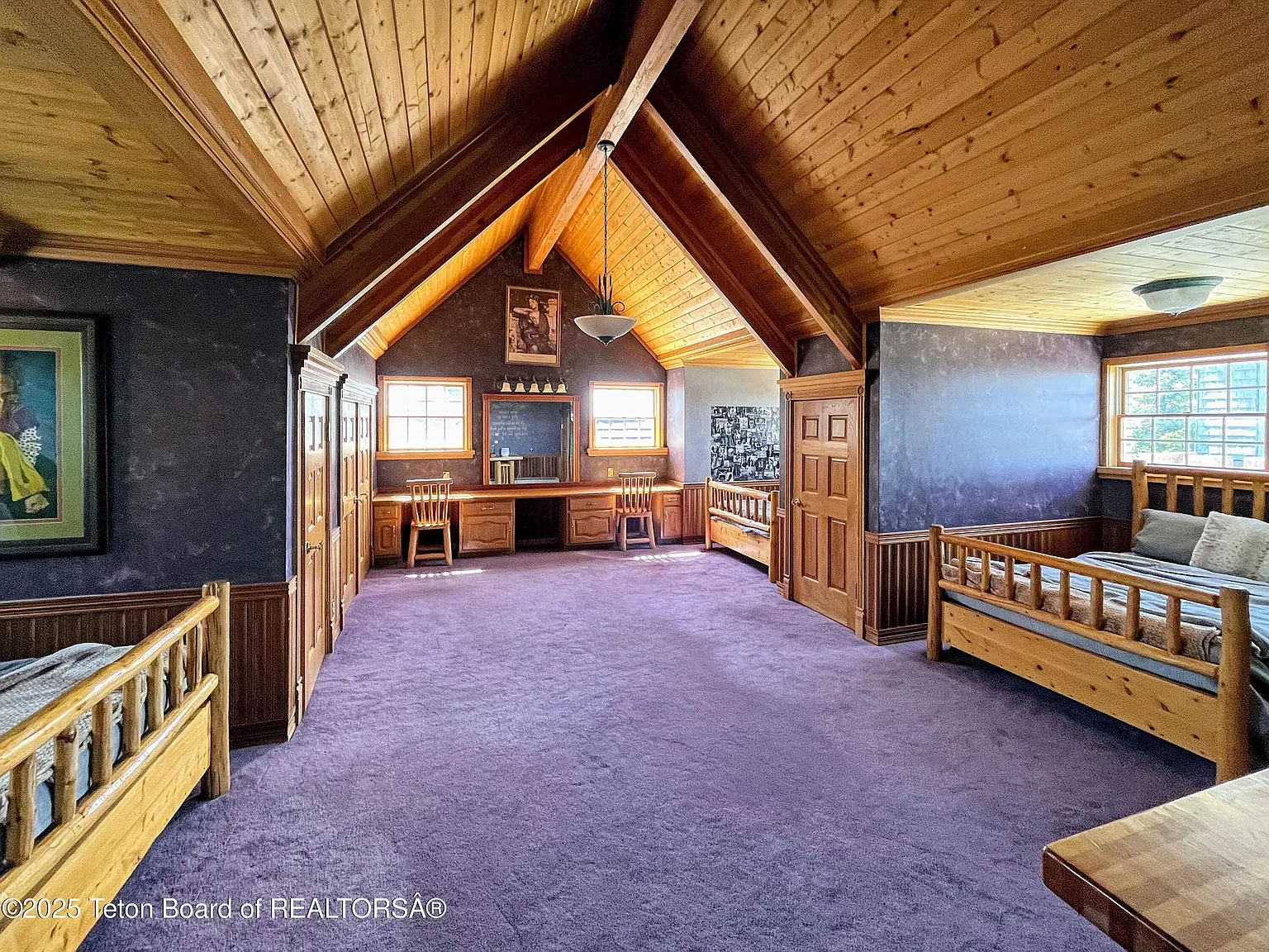 Cathedral wood ceiling for days. Feels a lodge loft.