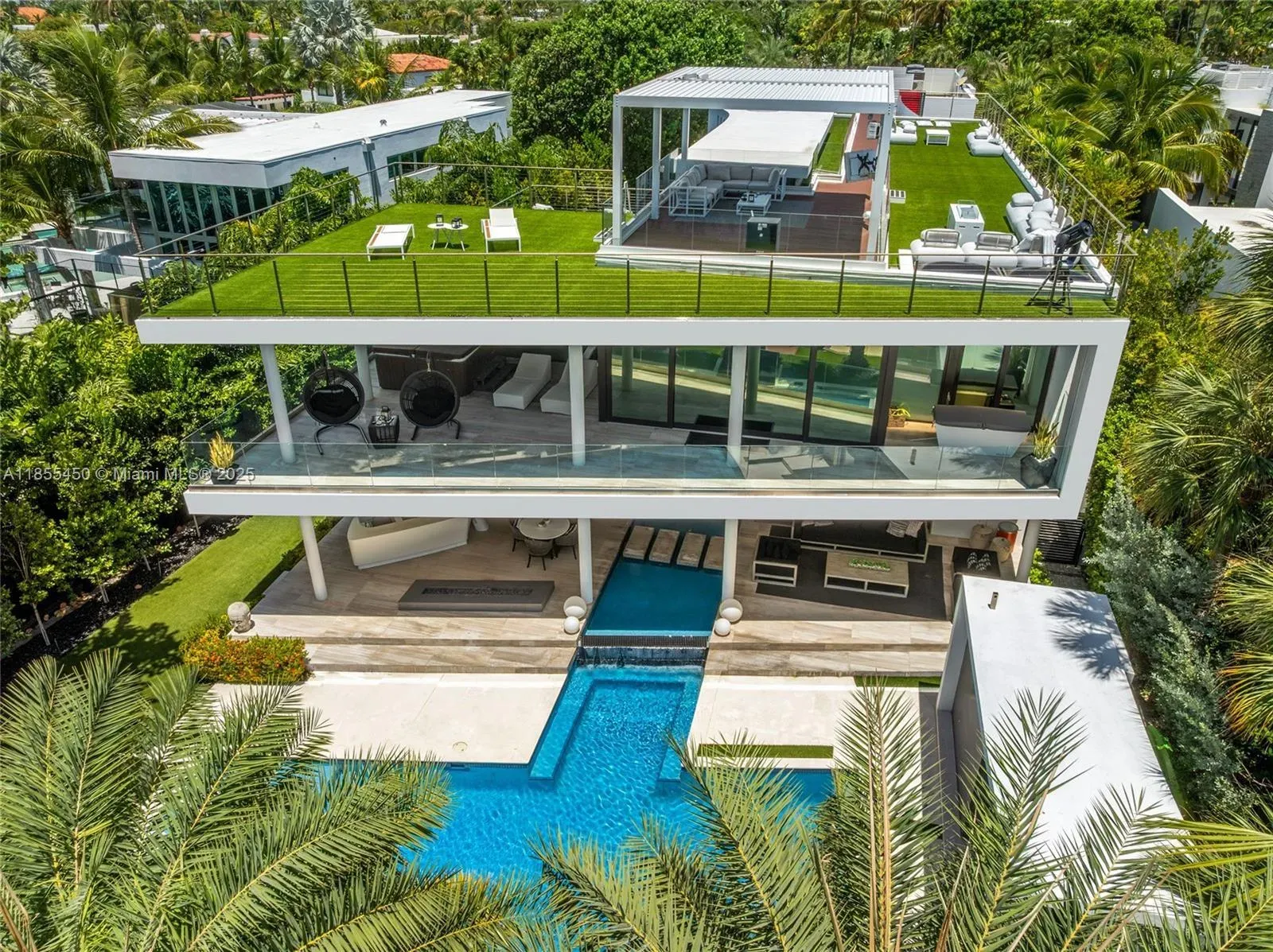 Back outside—tropical modern villa, huge glass, airy upper terrace. Breezy.