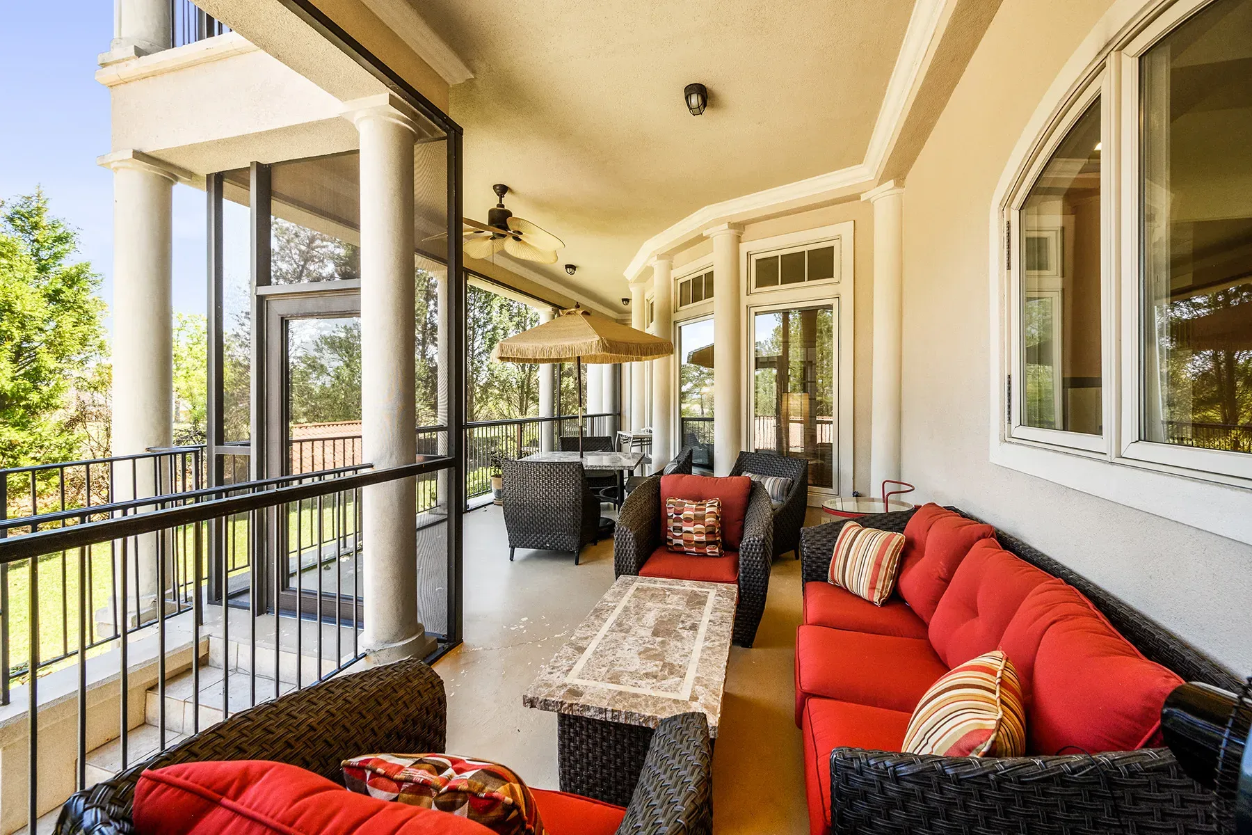And then a covered patio—wicker seating, red cushions, borderline resort.