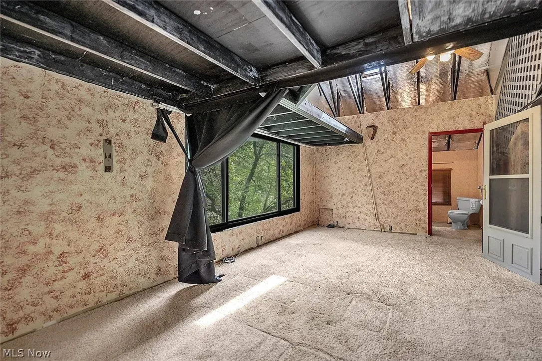 Exposed beams and contrast ceiling. Feels a cabin loft with potential.