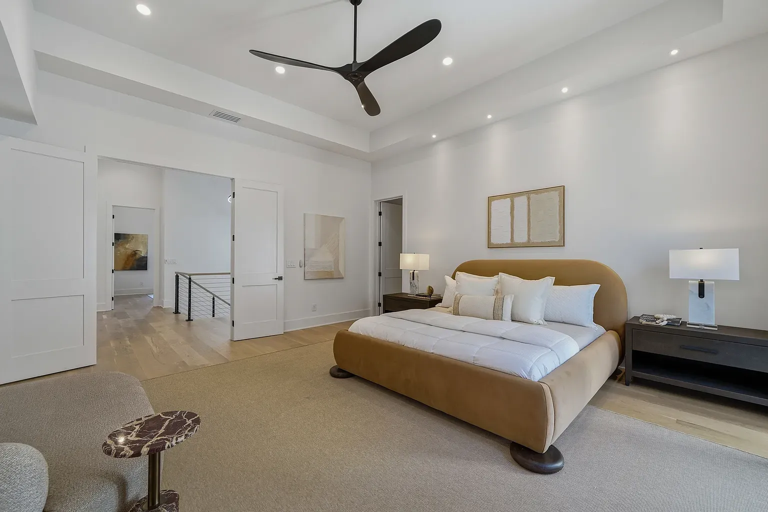 That curved tan headboard is the star. Rest of the room whispers.