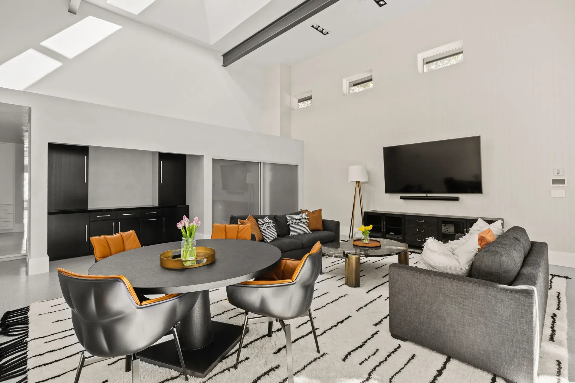 Skylights dumping light everywhere. Soft grays, then pops of black. Okay, this works.