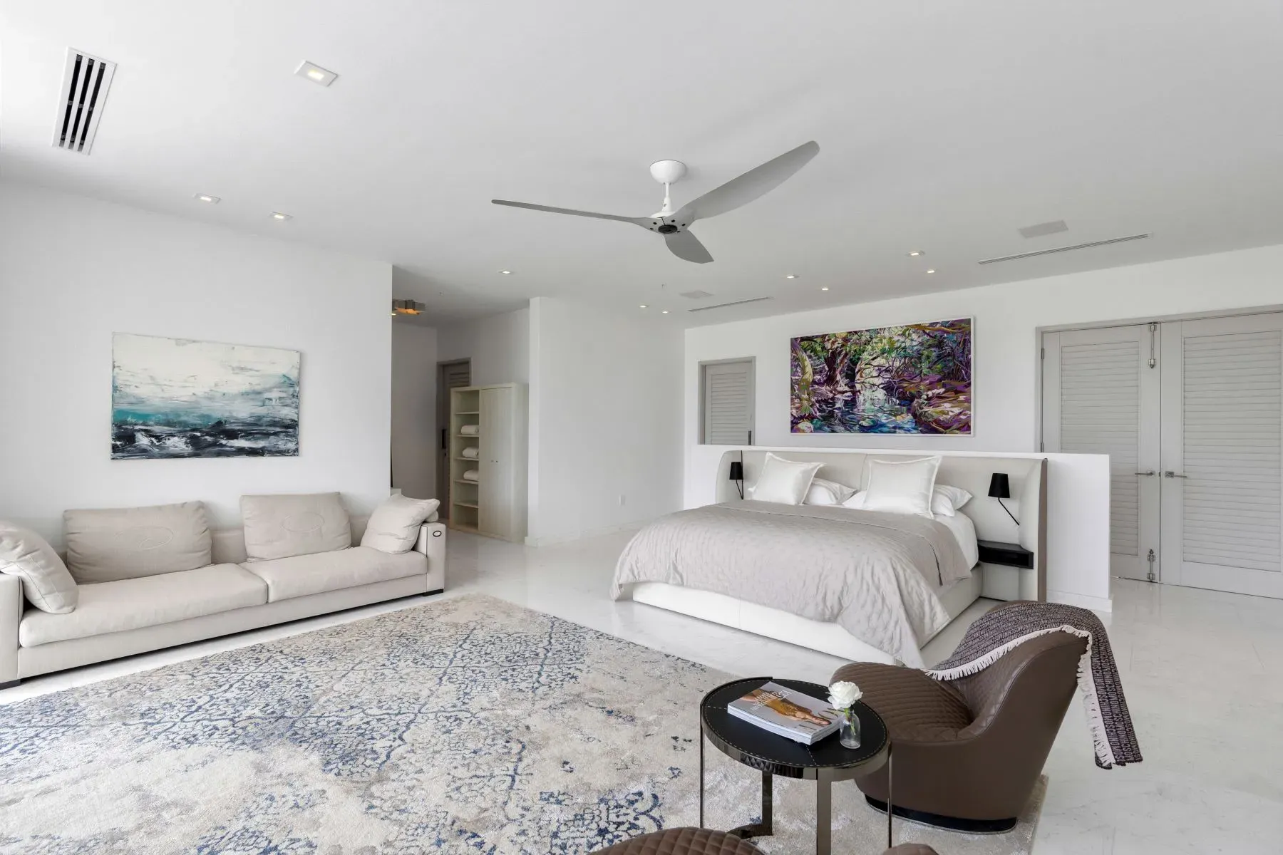 Primary suite goes full minimal—white walls, big bed, quiet. Sleep city.