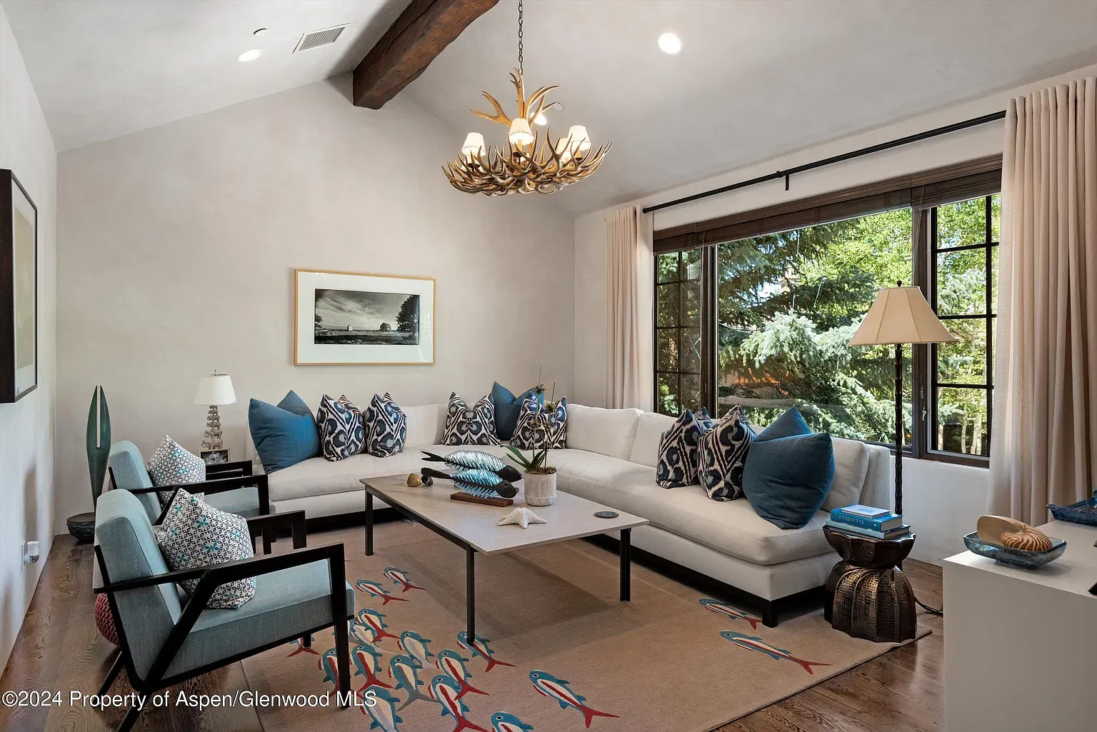 Another lounge with pale textured walls and warm beams. Easy, lived-in feel.