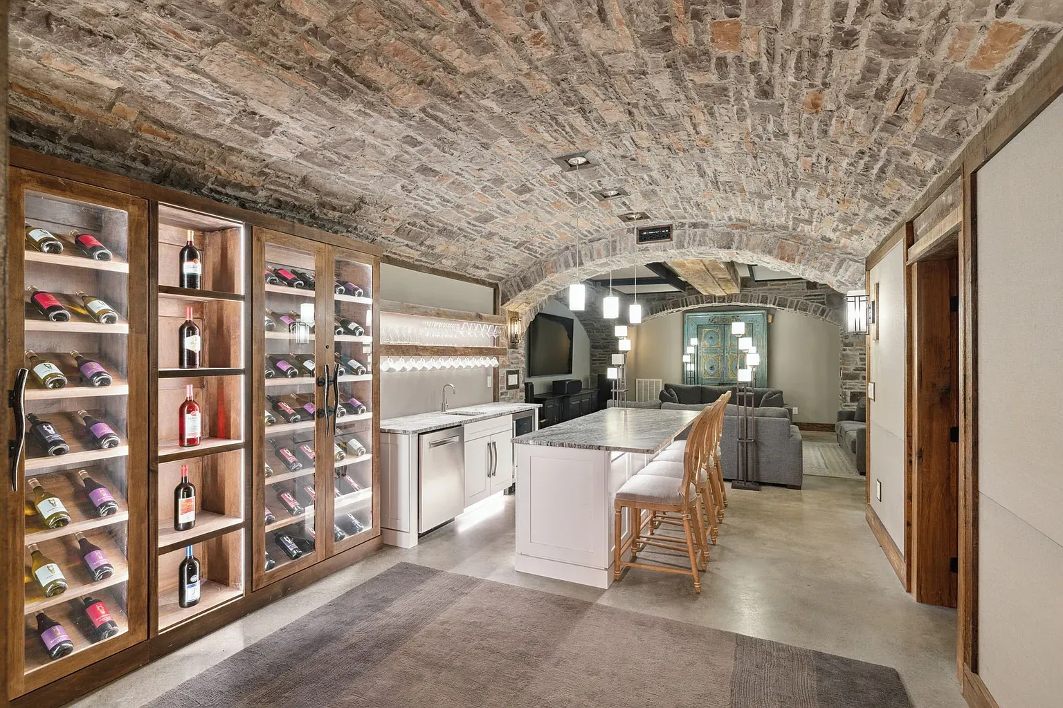 Arched stone wine room. Feels a secret tunnel but with snacks.