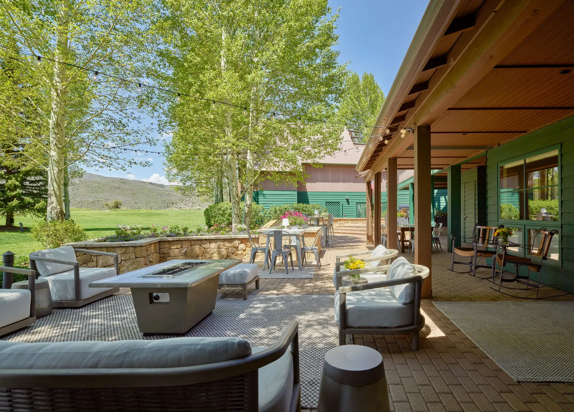 Big stone patio with a cozy seating zone. Feels party-ready.