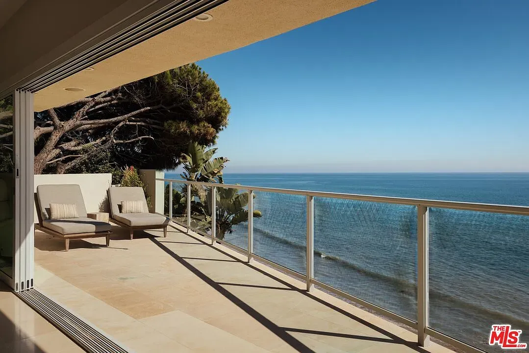 Okay, this balcony—massive sliders, breeze straight through. Minimal and kind of perfect.