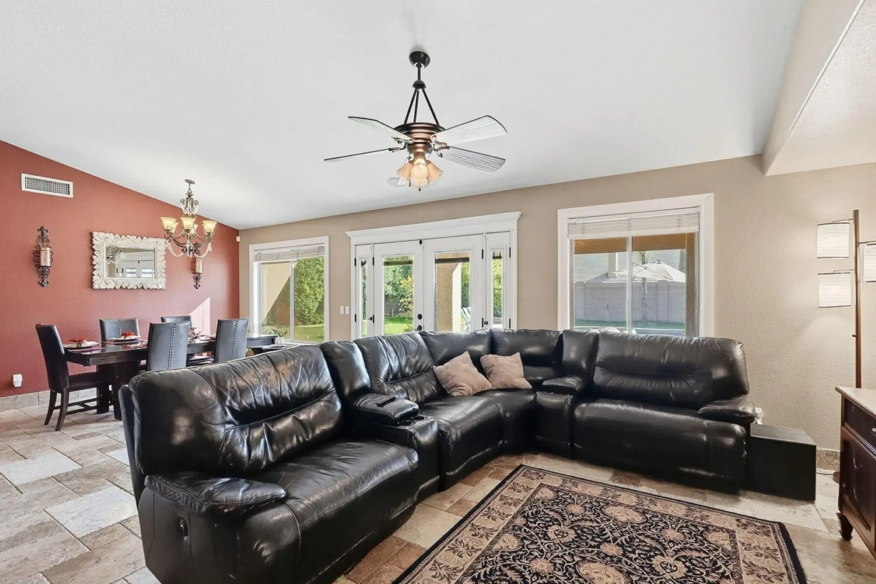 Big black leather sectional anchoring everything. Looks movie night central.