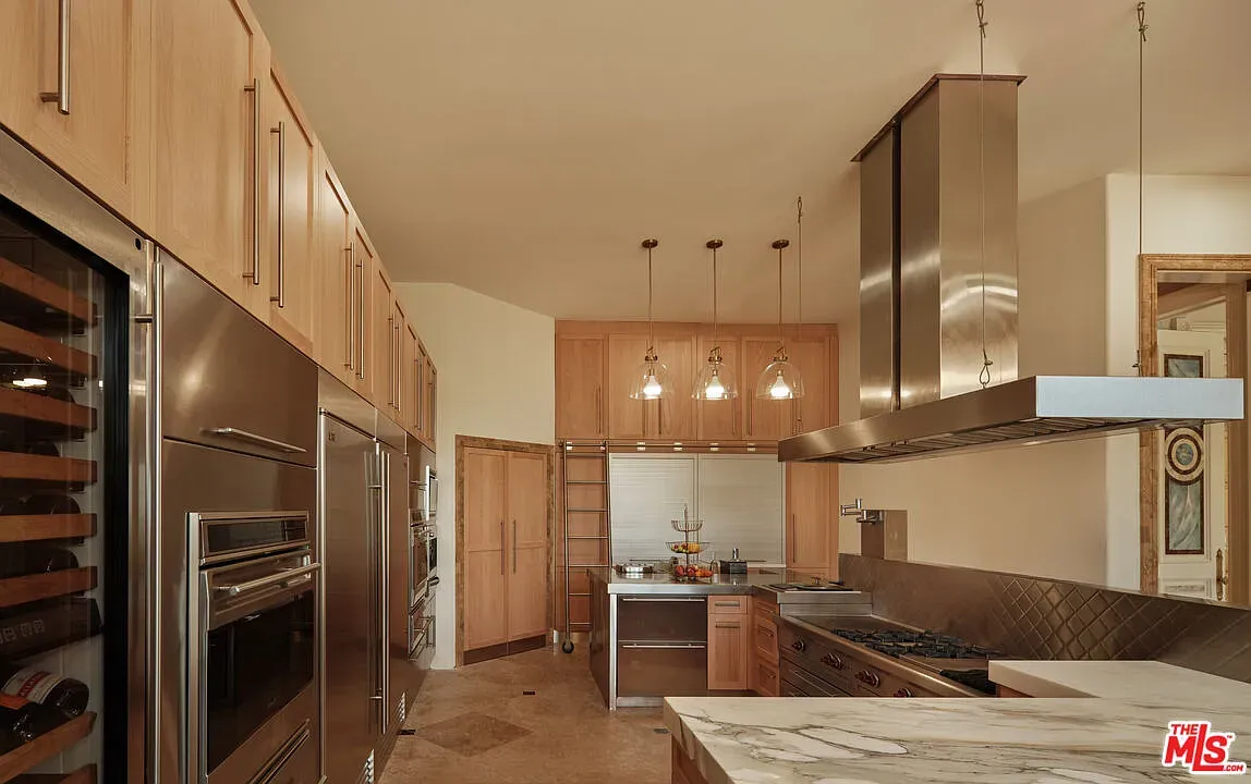 Warm oak kitchen with pro appliances. Love the sneaky wine fridge flex.