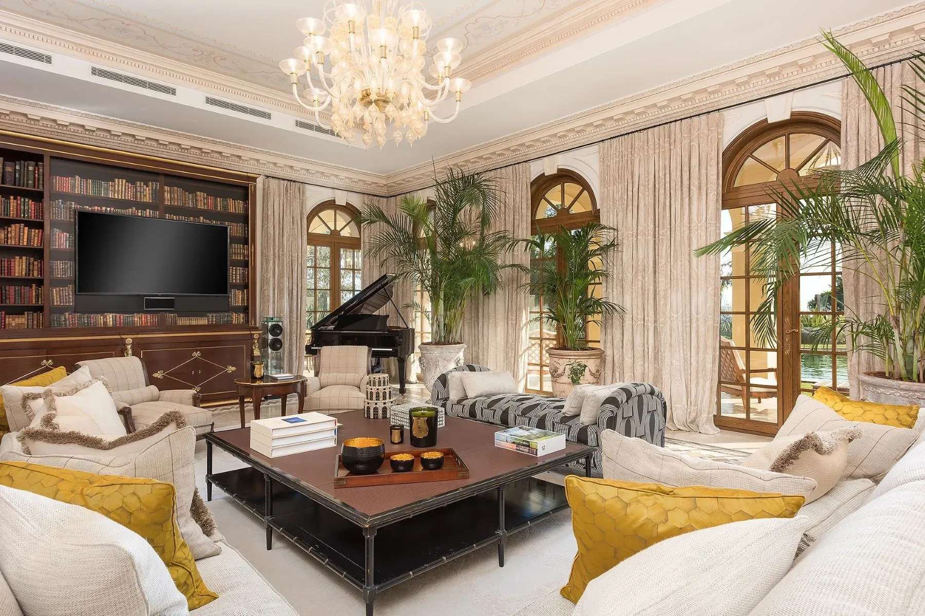 The chandelier’s doing a soft sparkle over those tall arched windows.