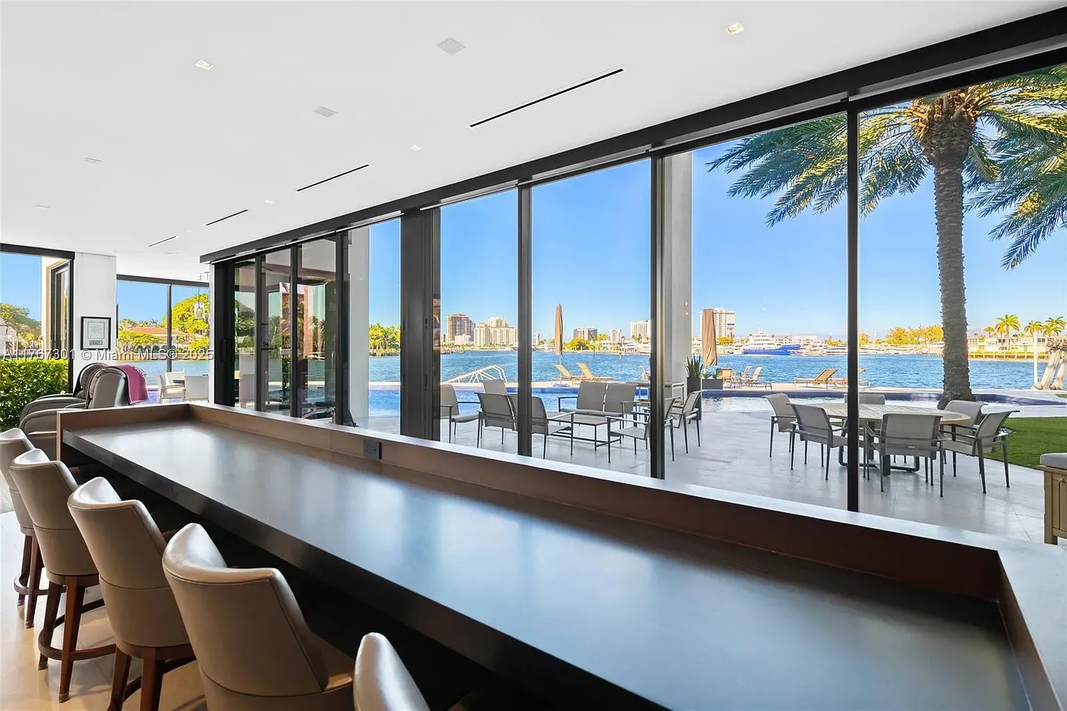 Indoor-outdoor bar moment facing the water. Dark wood top is slick.