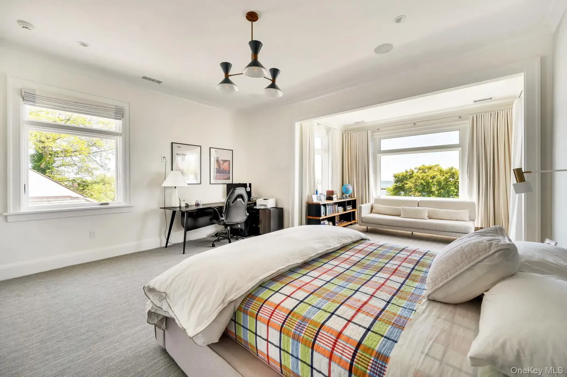 Plaid duvet brings the fun. Otherwise clean, calm bedroom.