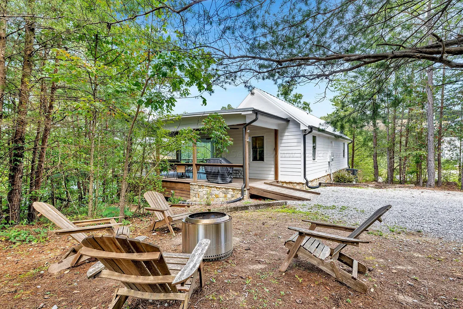 Adirondack corner tucked in the trees. Wood tones, looks a quiet hangout.