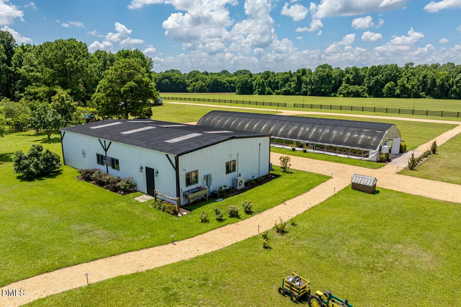 Another look. crisp white farmhouse, black roof, bright flower beds. Solid curb appeal.