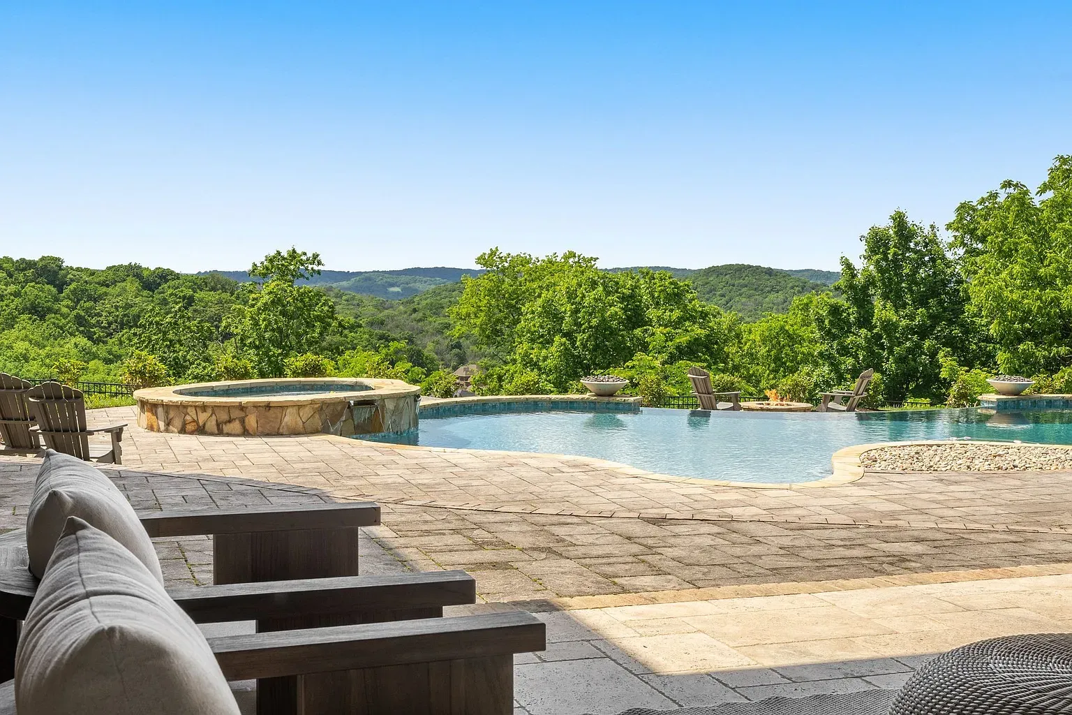 Infinity pool melting into the hills. That edge would get me every sunset.