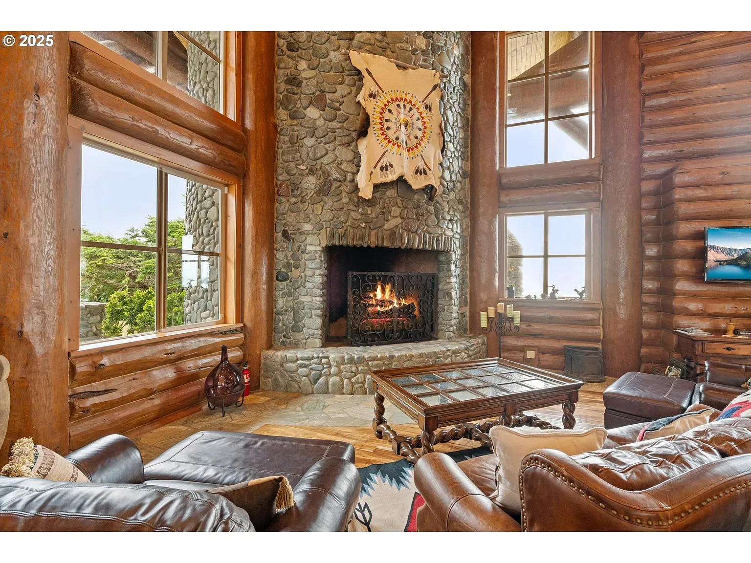 Main living room, giant stone fireplace and logs the size of trees.