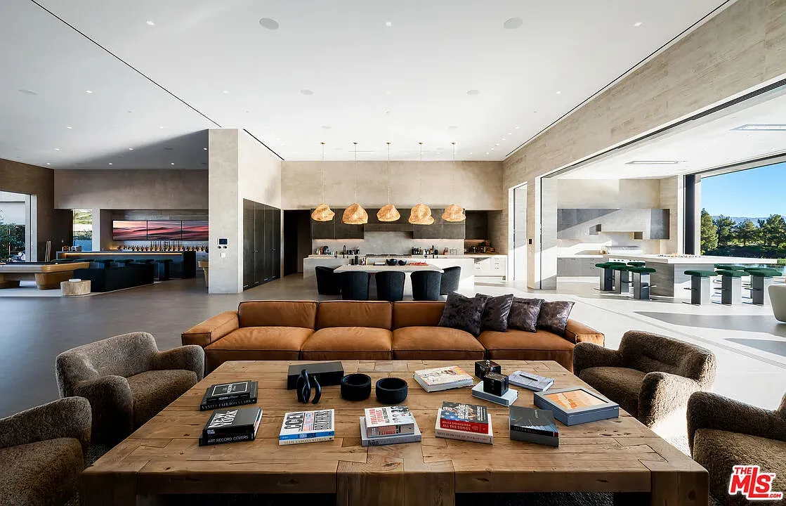 Open living-kitchen, beige and wood everywhere, very cozy without trying too hard.