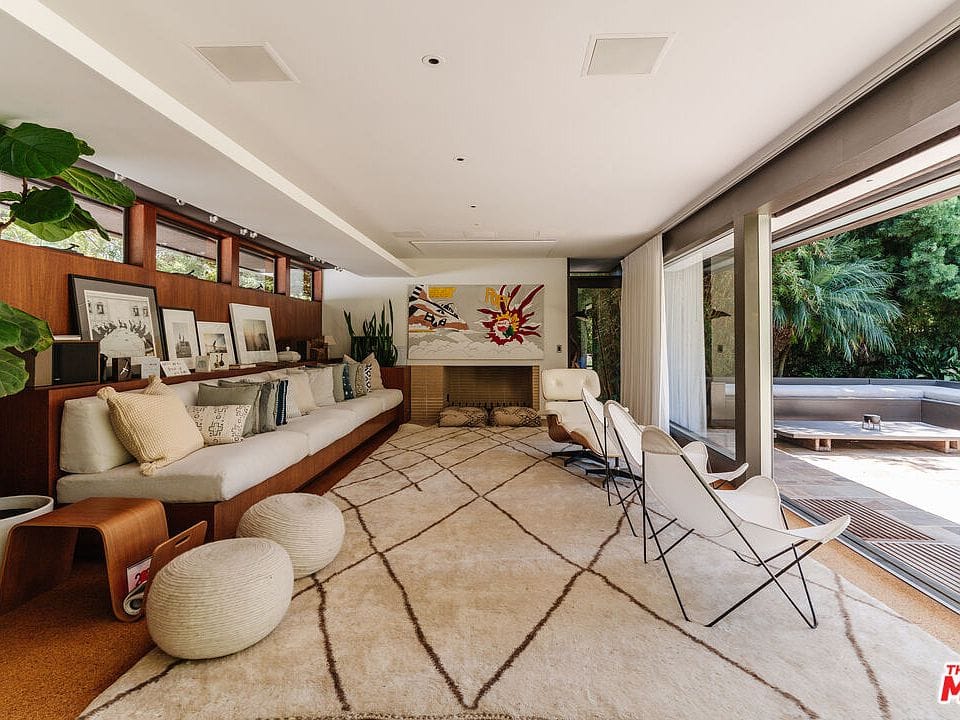 Long couch plus wood wall—movie nap zone unlocked.