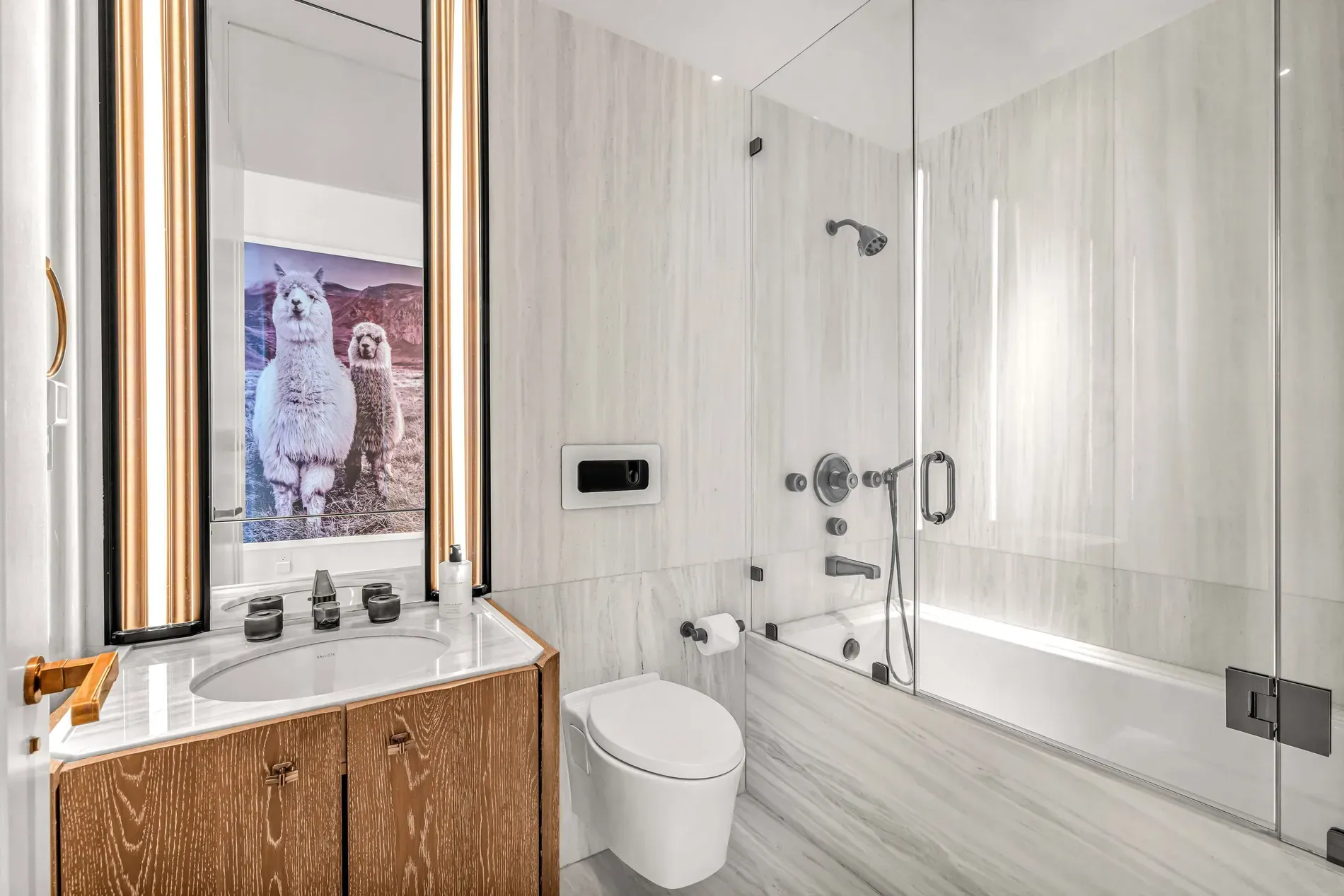 Bathroom spa vibes — big marble slabs, muted creams and grays.