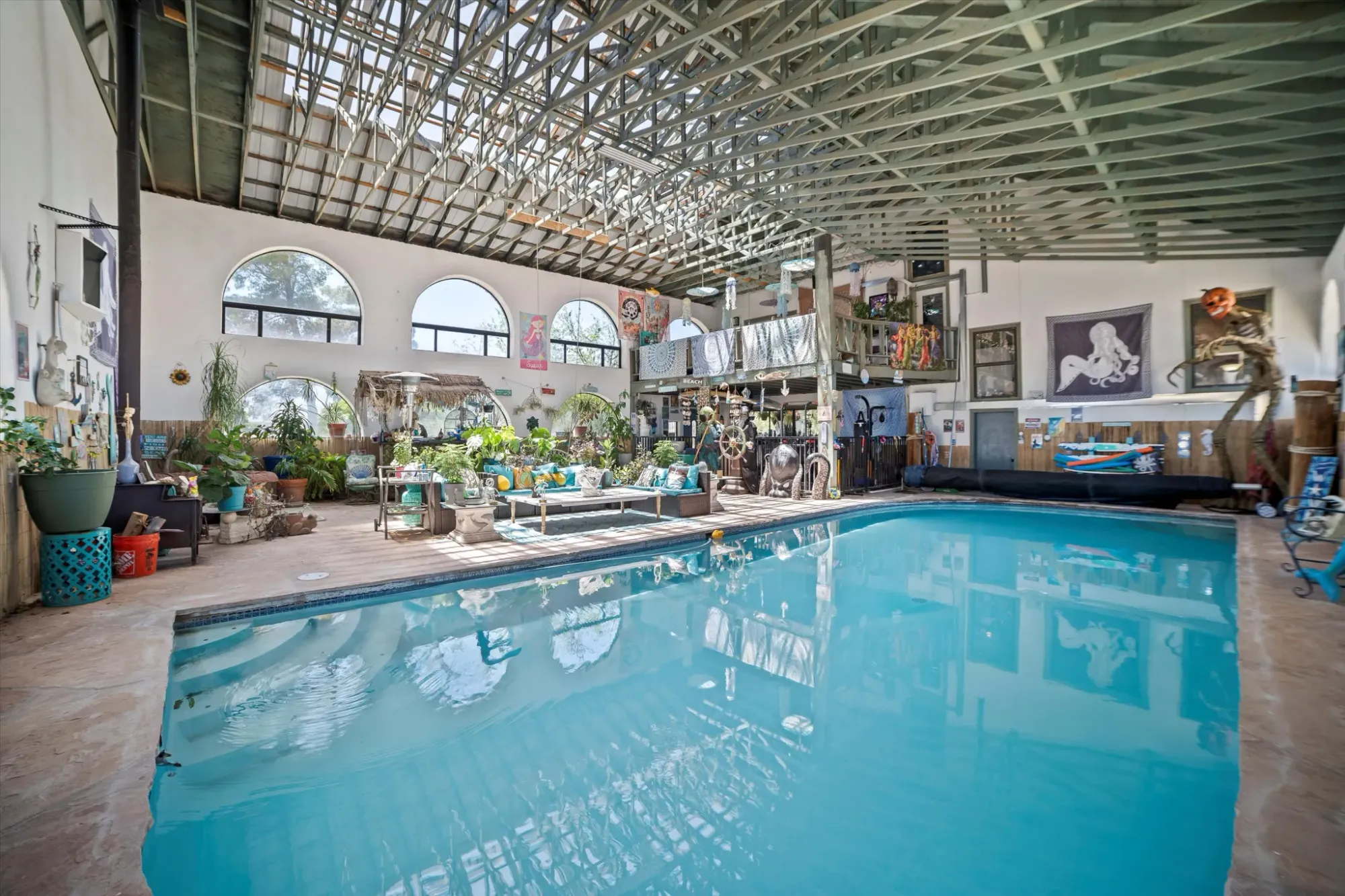 Indoor pool goals. Greenery everywhere, ceiling beams way up there.