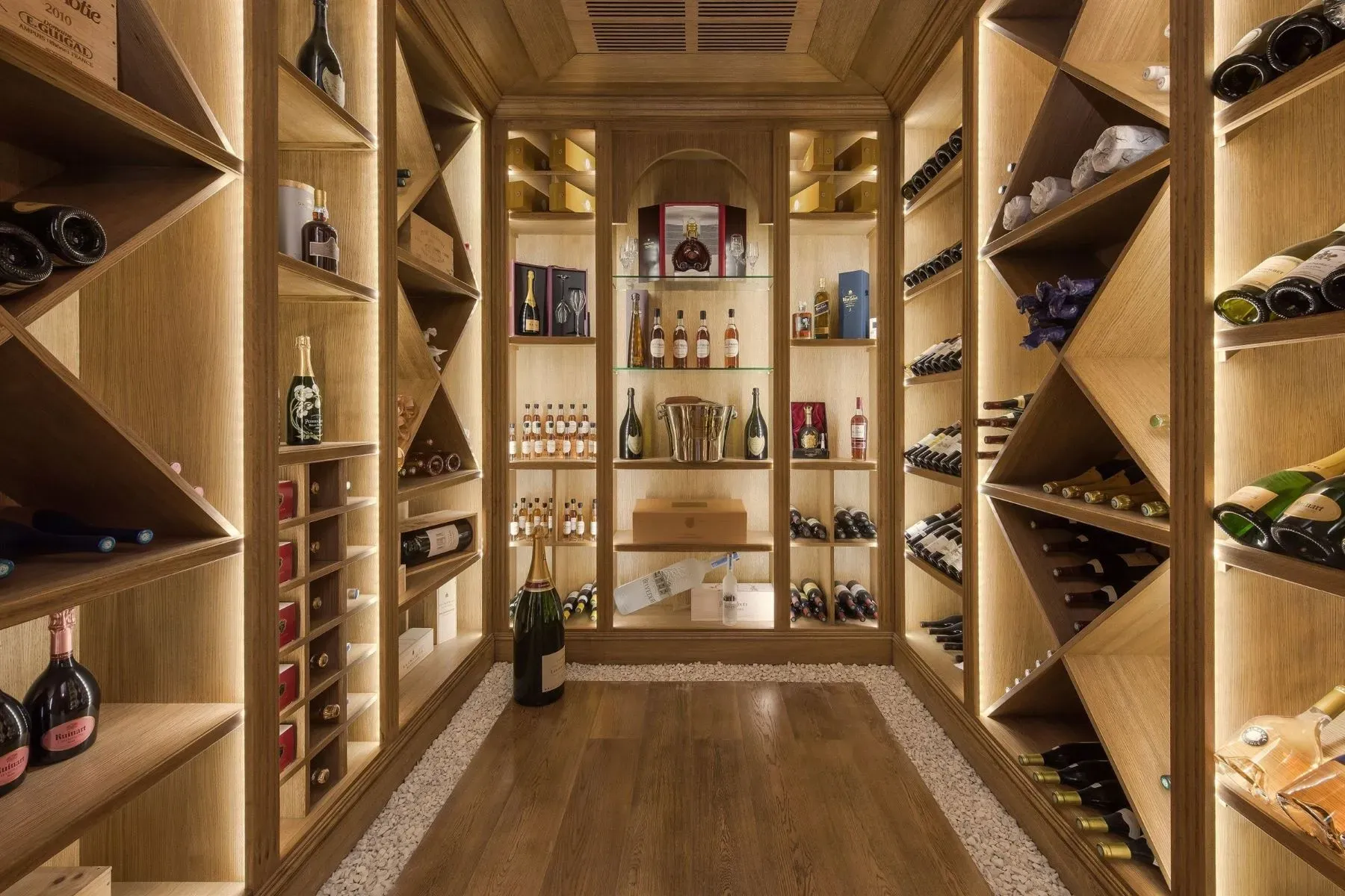 Wine room with oak everywhere and those diamond racks. Serious collector vibes.
